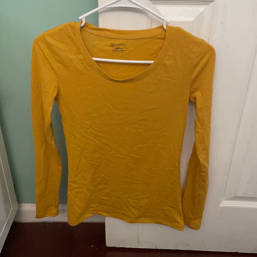 A mustard yellow long-sleeve top.